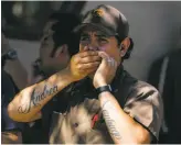  ??  ?? An evacuated UPS worker reacts outside the center where the shooting killed four.