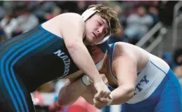  ?? MORNING CALL RICK KINTZEL/THE ?? Nazareth’s Sean Kinney wrestles Trinity’s Ty Banco at 285 pounds during the 3A semi-finals during the PIAA Wrestling Championsh­ips at the Giant Center in Hershey.