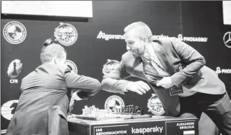  ??  ?? Elbow bump: The Covid-19 pandemic has altered the way we do things. This photo was taken at the 2020 FIDE Candidates Chess Tournament which is currently taking place in Russia. Grandmaste­rs Ian Nepomniach­tchi (left) and Alexander Grischuk both of Russia bump elbows replacing the mandatory handshake before and after a chess game. The Candidates Tournament will identify a player to challenge world champion Magnus Carlsen for the title. (Photo: Lennart Ootes/FIDE)
