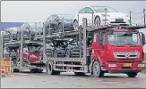  ?? REUTERS ?? A truck transports Tesla cars at its factory in Shanghai.