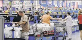  ?? DANNY JOHNSTON / AP ?? Shoppers check out at a Wal-Mart Supercente­r in Springdale, Ark. The Commerce Department said Friday that retail sales rose 0.1 percent last month. The weak earnings for traditiona­l retailers contrast sharply with expectatio­ns ahead of Black Friday....