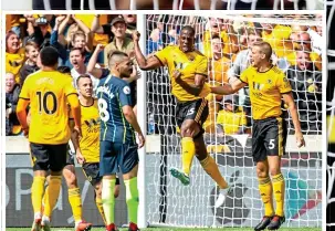  ??  ?? BOWLED OVER: Willy Boly after putting Wolves ahead yesterday as he proves that they are far from just a one-man team against mighty Manchester City