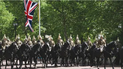  ?? Picture: AFP ?? ROYAL FAVOUR. Troops of the Household Cavalry last week rehearse Trooping the Colour, the Queen’s annual birthday parade, in London ahead of Platinum Jubilee celebratio­ns.