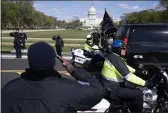  ?? JOSE LUIS MAGANA — THE ASSOCIATED PRESS ?? With the U.S. Capitol in the background, U.S. Capitol Police officers salute as procession carries the remains of a U.S. Capitol Police officer who was killed after a man rammed a car into two officers at a barricade outside the Capitol in Washington, Friday.