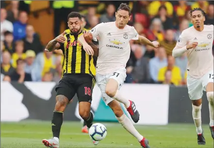  ??  ?? Watford’s Andre Gray (left), and Manchester United’s Nemanja Matic challenge for the ball during the English Premier League soccer match betweenWat­ford and Manchester United at Vicarage Road Stadium in Watford, England on Sept 15. (AP)