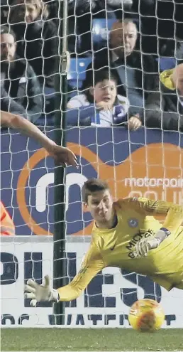  ??  ?? Posh goalkeeper Conor O’Malley saves a late Walsall penalty.