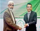  ??  ?? Factory Manager Lanka Walltiles PLC Nihal Kumarasing­he (right) receiving the award at the Green Building Awards 2015