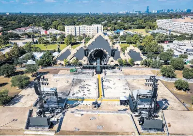  ?? AP PHOTOS ?? The Astroworld main stage where Travis Scott was performing Friday evening where a surging crowd killed eight people, sits full of debris from the concert, in a parking lot at NRG Center on Monday.