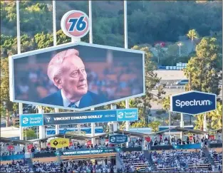  ?? Los Angeles Times/tns - Gina Ferazzi ?? An image of late Dodgers announcer Vin Scully appears on the video screen during a tribute to him before a game at Dodger Stadium last week in Los Angeles.