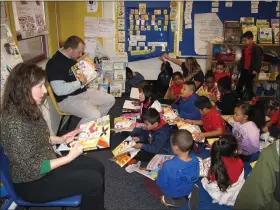  ??  ?? Chris Major from United Way and Michele Moll from RSVP visit classrooms at Gotwals Elementary to present new books and read to eager students.