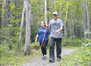  ?? GREG MCNEIL/CAPE BRETON POST ?? Audrey and Wade Bennett of Westmount made their way down a scenic hiking trail at Petersfiel­d Park on Monday. Leaves on the trees that surrounded them were already starting to show signs of colour change to signify the arrival of fall. The unseasonab­ly...