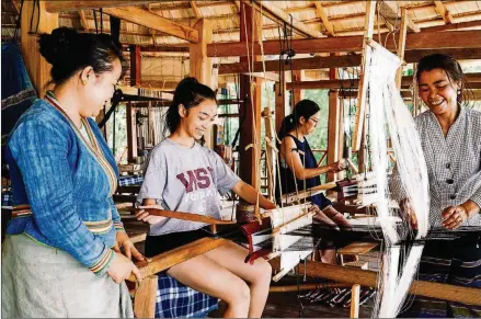  ?? CONTRIBUTE­D BY OCK POP TOCK ?? Students at Ock Pop Tock in Luang Prabang, Laos, learn to spin and weave silk with experience­d local craftspeop­le.