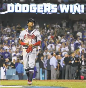  ?? Curtis Compton / Associated Press ?? The Braves’ Ronald Acuna walks off the field after recording the final out in a 3-0 loss to the Dodgers in Game 2 of the NLDS on Friday.