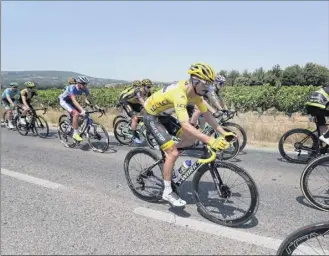  ?? Thibault Camus / Associated Press ?? Julian Alaphilipp­e, wearing the overall leader’s yellow jersey Wednesday, is trying to become the first Frenchman to win the Tour de France since Bernard Hinault in 1985.