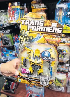  ?? AP ?? Hasbro Inc’s Transforme­rs are displayed at a toy store in Palo Alto, California. Hasbro said on Monday that toys geared toward boys increased 21%, with a strong showing from Transforme­rs, Nerf and Marvel.