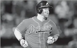  ?? KEVIN C. COX/GETTY IMAGES/AFP ?? Brian McCann reacts after hitting a two-run homer for the Atlanta Braves against the San Diego Padres in September. McCann, who became one of baseball’s most coveted free agents last month, has signed a five-year contract with the New York Yankees that...