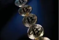  ?? JUSTIN TALLIS/AFP/GETTY IMAGES ?? The value of one Bitcoin has skyrockete­d to $11K (U.S.).