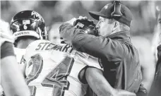  ?? GEOFF BURKE, USA TODAY SPORTS ?? Ravens coach John Harbaugh hugs safety Darian Stewart.