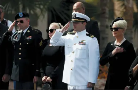  ?? ROSS D. FRANKLIN — THE ASSOCIATED PRESS ?? Cindy McCain, right, joined by her sons Jack McCain, and Jimmy McCain, left, and daughter Meghan, second from left, watch as the casket of Sen. John McCain, R-Ariz., is taken from the hearse as they all arrive prior to a memorial service at North Phoenix Baptist Church Thursday in Phoenix.