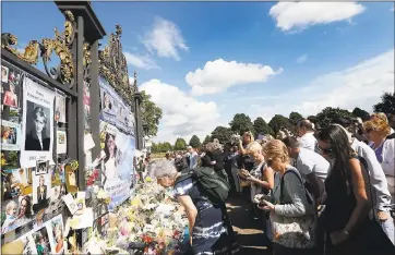  ?? KIRSTY WIGGLESWOR­TH — THE ASSOCIATED PRESS ?? Twenty years later, people crowd around the gates at Kensington Palace in London on Thursday to pay tribute to Diana, Princess of Wales. Diana died in a car crash in Paris on Aug. 31, 1997.