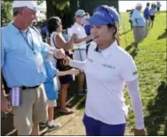  ?? SETH WENIG — THE ASSOCIATED PRESS ?? South Korea’s Hye-Jin Choi is greeted by fans and tournament volunteers as she walks to the 16th tee during the final round of the U.S. Women’s Open Golf tournament Sunday in Bedminster, N.J.