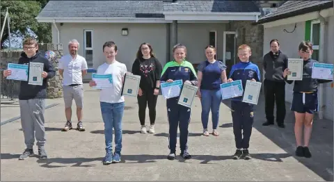  ??  ?? (Front, from left) Ballyhogue NS sixth class pupils Jack Redmond, Kian Dagg, Chelsea Doyle, Cian Fortune and Anthony Byrne with (back) principal James Roberts, teachers Michelle Furlong and Marria Sugrue and Fr Billy Caulfield at their graduation.