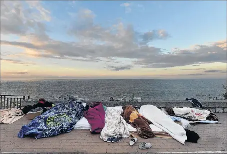  ?? PHOTO: LUCA ZENNARO/EPA ?? SUFFERING: Migrants sleep in Ventimigli­a, Italy, yesterday. Plans to tackle a migration surge hit a hurdle as the European Union interior ministers clashed over plans to redistribu­te asylum seekers