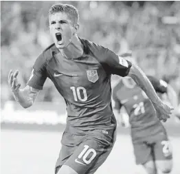  ?? JOHN RAOUX/AP ?? Christian Pulisic celebrates his eighth-minute goal during the first half of Team USA’s World Cup qualifier against Panama on Friday in Orlando.