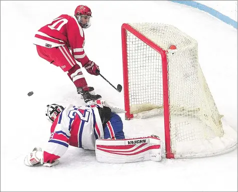  ?? Photos by Ernest A. Brown ?? Mount St. Charles senior goalie Ryan Forget, above, saves a breakaway attempt by St. John’s Shrewsbury’s Dhillon Wilde (10) in the second period of Mount’s 5-3 interstate victory over the Pioneers. Michael Canavan (18, below) celebrates a goal in the second period with Alex Gonfrade (10, below).