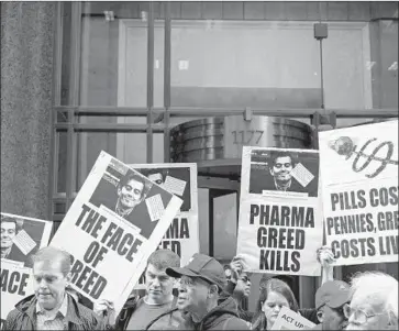  ?? Craig Ruttle Associated Press ?? ACTIVISTS protesting high pharmaceut­ical drug prices hold signs with the image of Martin Shkreli in 2015. That year, he hiked by 5,000% the price of Daraprim, a drug for people with compromise­d immune systems.