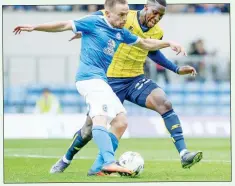  ??  ?? HUNGRY: Chey Dunkley, right, on defensive duties for the U’s