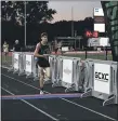  ?? PAUL DICICCO — FOR THE NEWS-HERALD ?? Mitchell Klingler of Coldwater, Mich, crosses the finish line with a time of 14:18 at the Friday Night Lights race in Mentor on July 24.