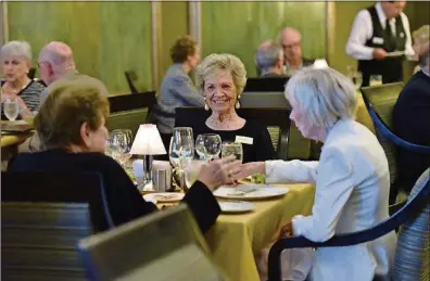  ?? HYOSUB SHIN / HSHIN@AJC.COM ?? Residents (from left) Isabel Barber, Shirley Caruso and Mari Doyal eat dinner at Lenbrook Fine Dining in Lenbrook Senior Community in Buckhead. With three distinctiv­ely focused dining venues in addition to The Club (a fourth restaurant that operates outdoors during warm weather months), an in-house TV menu channel and a resident food committee, the community is at the leading edge of a wave of change coming to dining in what’s broadly known as “senior living.”