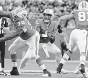  ?? AL DIAZ adiaz@miamiheral­d.com ?? Dolphins quarterbac­k Tua Tagovailoa sets up to pass against the Cowboys at Hard Rock Stadium in December.