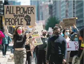  ?? PAT NABONG/SUN-TIMES ?? Hundreds of protesters march down Michigan Avenue on Saturday.