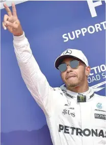  ?? — AFP ?? Mercedes’ driver Lewis Hamilton celebrates winning the pole position after the qualifying session at the Spa-Francorcha­mps circuit in Spa on Saturday ahead of the Belgian Grand Prix.