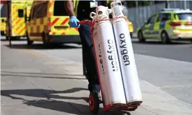  ?? Photograph: Andy Rain/EPA ?? Hospital staff move oxygen tanks outside the Royal London hospital last Friday.