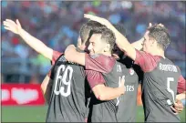  ??  ?? AC Milan’s Andre Silva (69) celebrates with teammates after scoring the only and winning goal against the FC Barcelona in the second half.