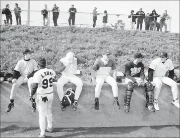  ?? Brennan Linsley Associated Press ?? WITH MAJOR LEAGUERS on strike, teams had to find replacemen­t players for spring training in 1995. These were some of the amateurs and former pros who made the cut at an Angels tryout in Fullerton.