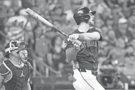  ?? PHOTOS BY TROY TAORMINA/USA TODAY SPORTS ?? Astros right fielder Kyle Tucker hits a three-run homer during the seventh inning against the Brewers on Sunday afternoon at Minute Maid Park.