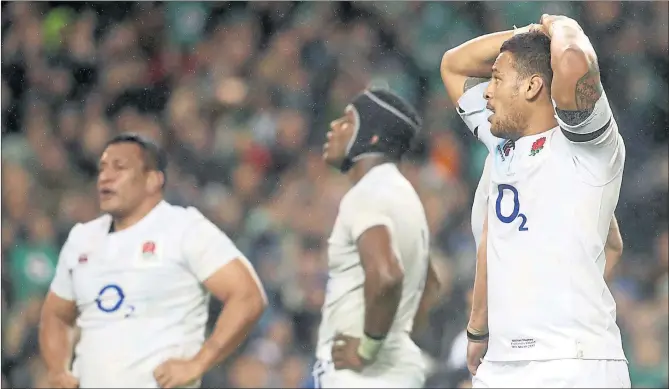  ??  ?? AT A LOSS: England’s Nathan Hughes, right, stand dejected after his team’s defeat against Ireland ended their winning run.