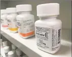  ?? Tribune News Service ?? An OxyContin bottle on a pharmacy shelf. Studies show abuse by snorting or injecting the reformulat­ed painkiller did fall after Purdue Pharma LP changed OxyContin a decade ago, but oral abuse, increased slightly.