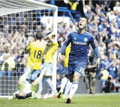  ?? Alastai
r Grant / The Associat ed Press ?? Chelsea’s Eden Hazard, right, celebrates after scoring the opener during the English Premier League soccer match Sunday between Chelsea and Crystal Palace in London.