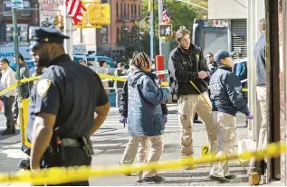  ?? AP-Yonhap ?? New York Police Department officers investigat­e the scene of an attack in Manhattan’s Chinatown neighborho­od in New York, Saturday. Four men who are believed to be homeless were attacked and killed early Saturday in a street rampage.