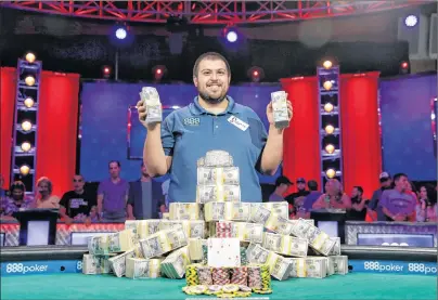  ?? AP PHOTO/JOHN LOCHER ?? Scott Blumstein poses for photograph­ers after winning the World Series of Poker main event, Sunday, July 23, in Las Vegas.