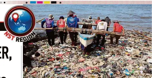  ?? AFP PIC ?? Fishermen struggling to get a boat to sea through a swath of plastic waste choking Sukaraja beach in Bandar Lampung, Sumatra recently.