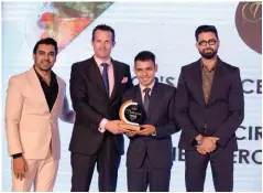  ??  ?? (Third from left) Manoj Bisht, Head Bartender of Cirrus 9, and Simon Rastrick, Executive Assistant Manager, F&B, The Oberoi, New Delhi receive the Editor’s Choice award for Best Rooftop Bar from designers Shivan & Narresh.