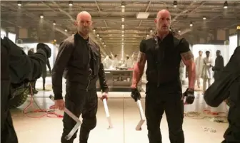  ??  ?? Jason Statham, left, and Dwayne Johnson reunite in “Fast & Furious Presents: Hobbs & Shaw,” directed by David Leitch.