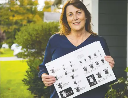  ?? FRaNCIS GEORGIAN ?? Vancouver artist Karin Jager displays the original artwork mockups of the logo she designed for the World Food Programme in 1987. Last week, the World Food Programme won the Nobel Peace Prize, and still uses her logo. Designing the logo was Jager's first major internatio­nal project.