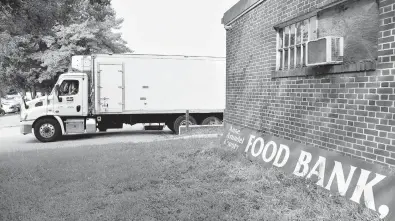  ?? PAUL W. GILLESPIE/CAPITAL GAZETTE ?? A delivery truck backs into the loading dock at the Anne Arundel County Food Bank, where Royal Farms donated 10 tons of food, including bread, milk, ham, cheese, water and turkey, on Tuesday morning.